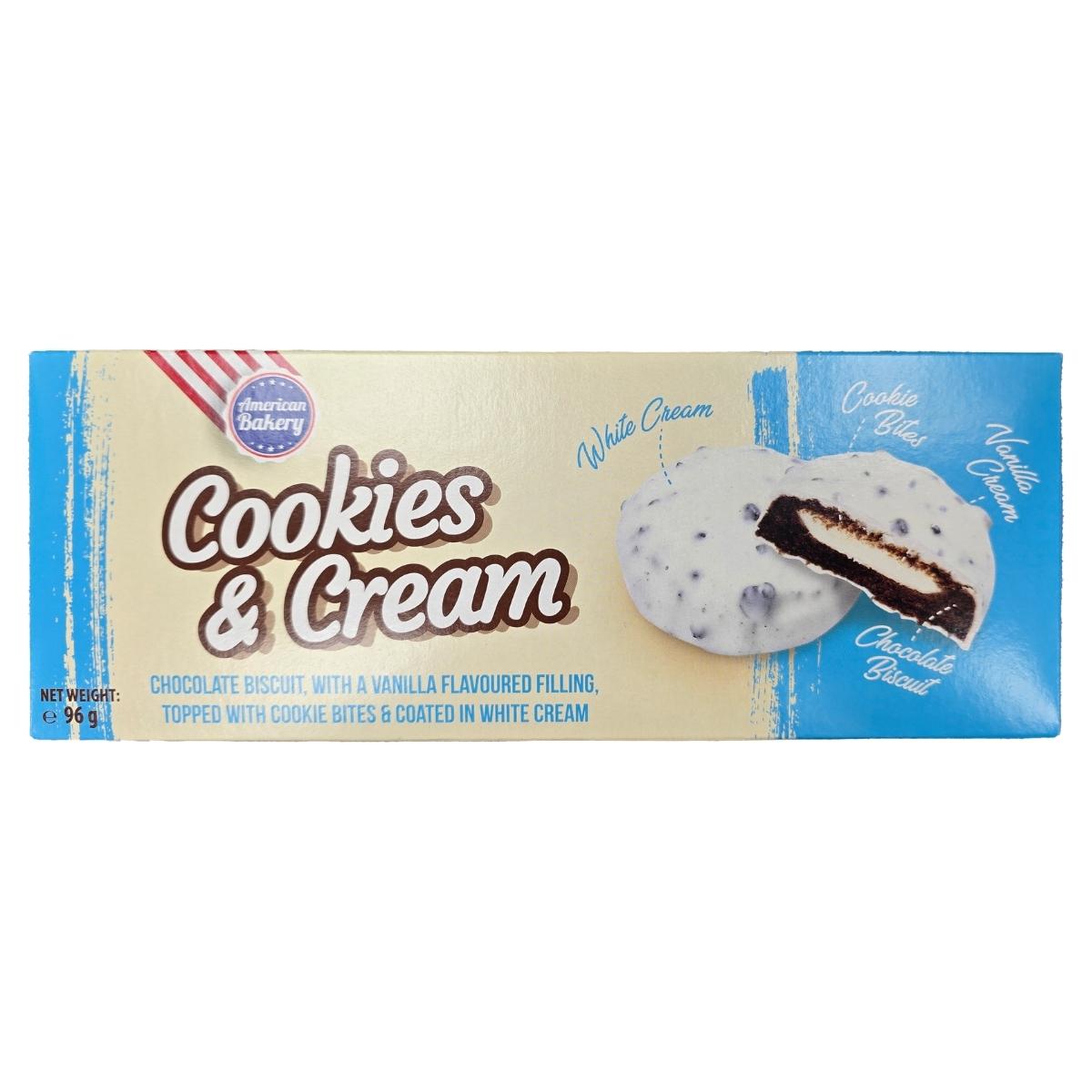 The "American Bakery - Cookies & Cream - 96g" boasts cocoa biscuits filled with vanilla cream, topped with cookie bites, and coated in luscious white compound. The "American Bakery - Cookies & Cream - 96g" boasts cocoa biscuits filled with vanilla cream, topped with cookie bites, and coated in luscious white compound.