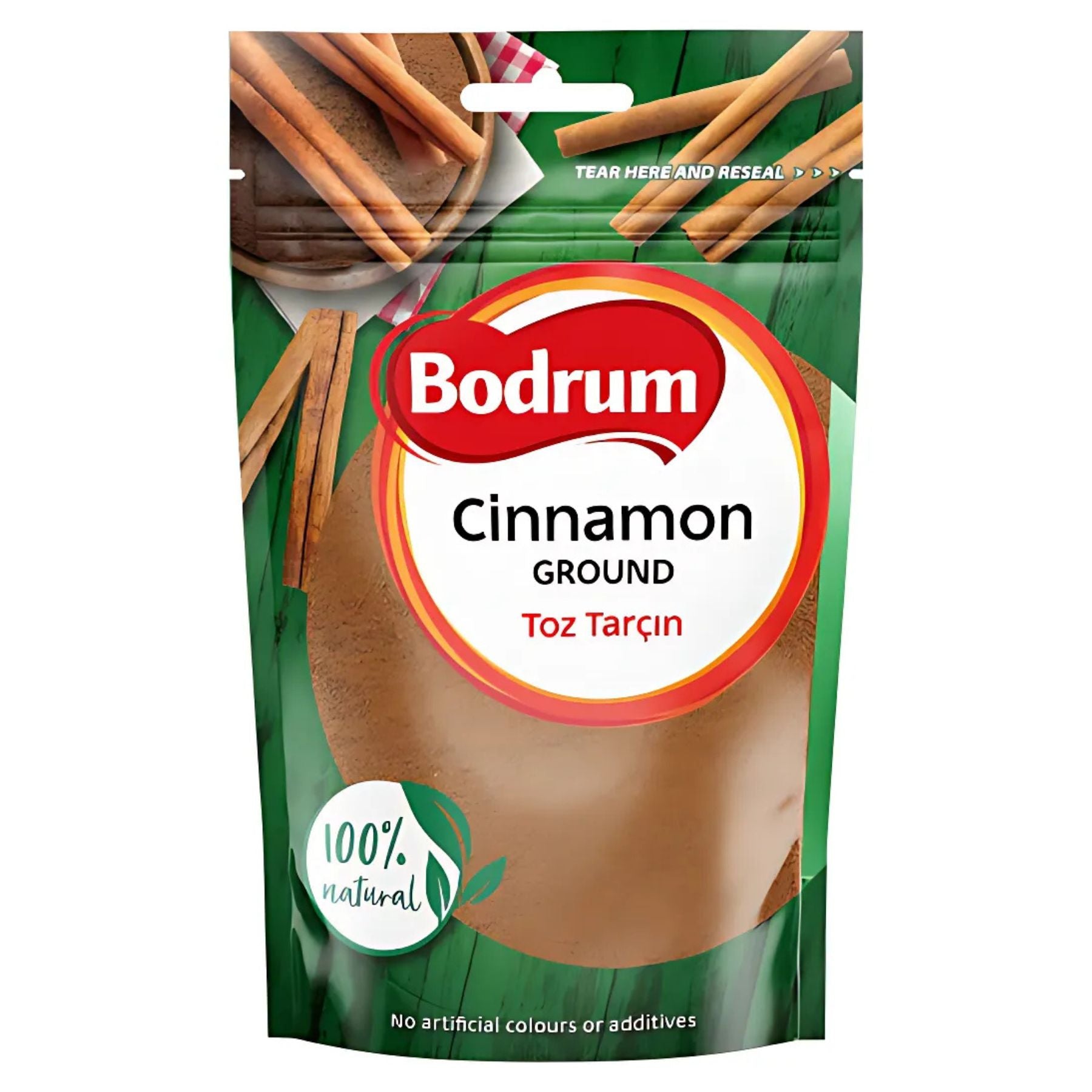 A 100g package of Bodrum Ground Cinnamon, labeled "100% natural," features cinnamon stick images on a green background and states "No artificial colours or additives. A 100g package of Bodrum Ground Cinnamon, labeled "100% natural," features cinnamon stick images on a green background and states "No artificial colours or additives.