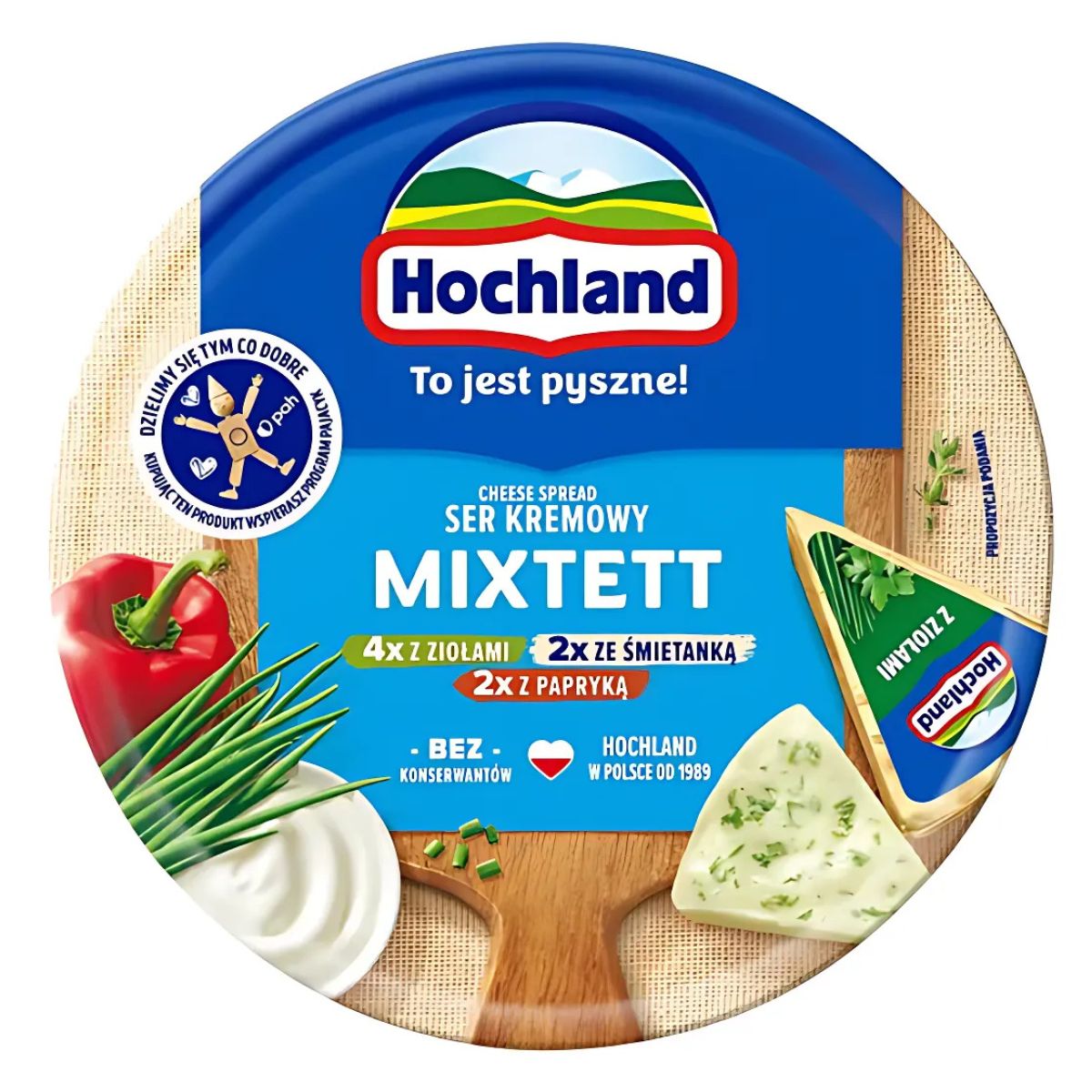 Hochland - Mixtett Cream Cheese, 180g round pack, shows cheese slices, red pepper, herbs, and Polish product info on the lid. Hochland - Mixtett Cream Cheese, 180g round pack, shows cheese slices, red pepper, herbs, and Polish product info on the lid.