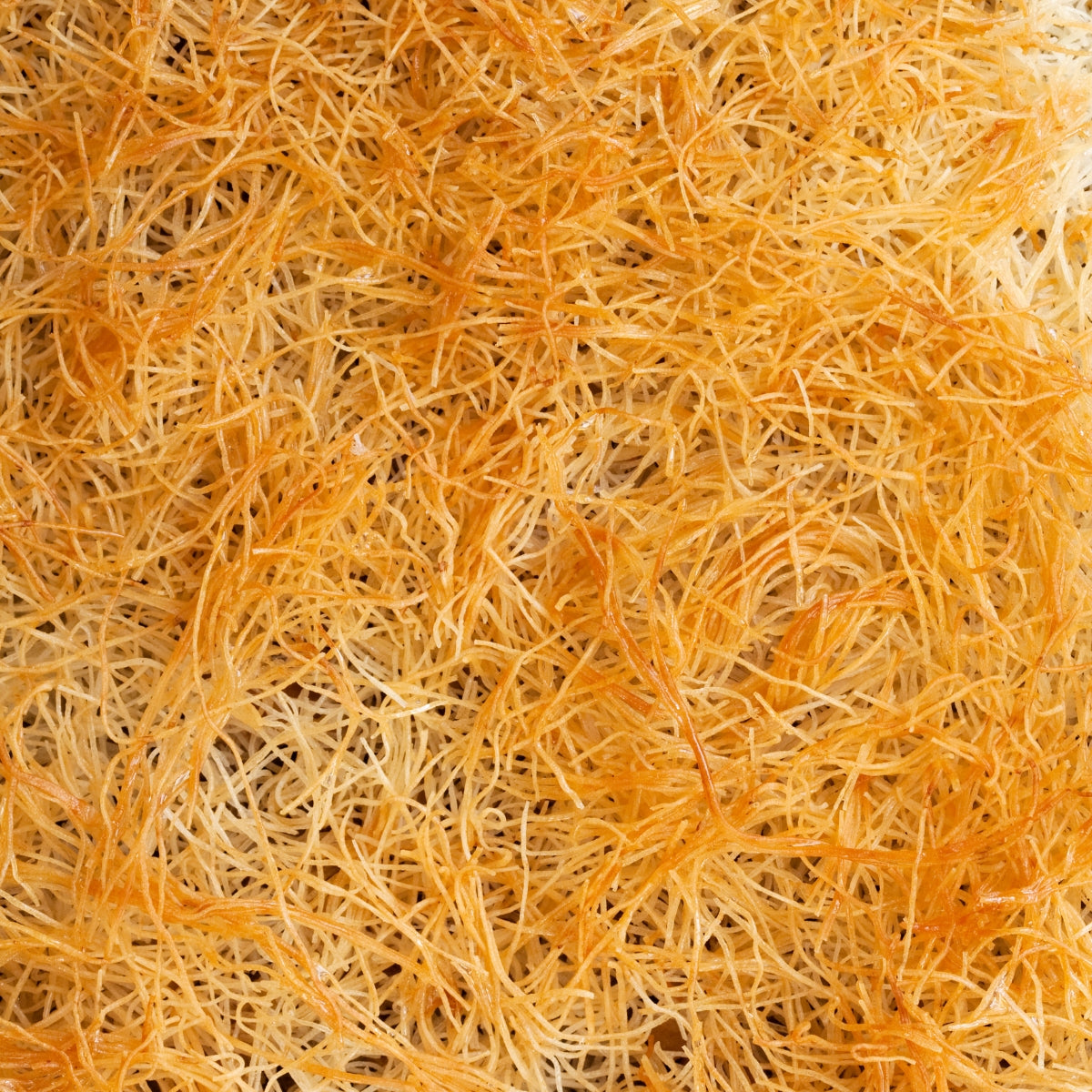 Close-up of golden, crispy strands of Theos - Fresh Kadayif (Kataifi) Shredded Fillo Dough, evoking Dubai's exquisite culinary artistry. Close-up of golden, crispy strands of Theos - Fresh Kadayif (Kataifi) Shredded Fillo Dough, evoking Dubai's exquisite culinary artistry.