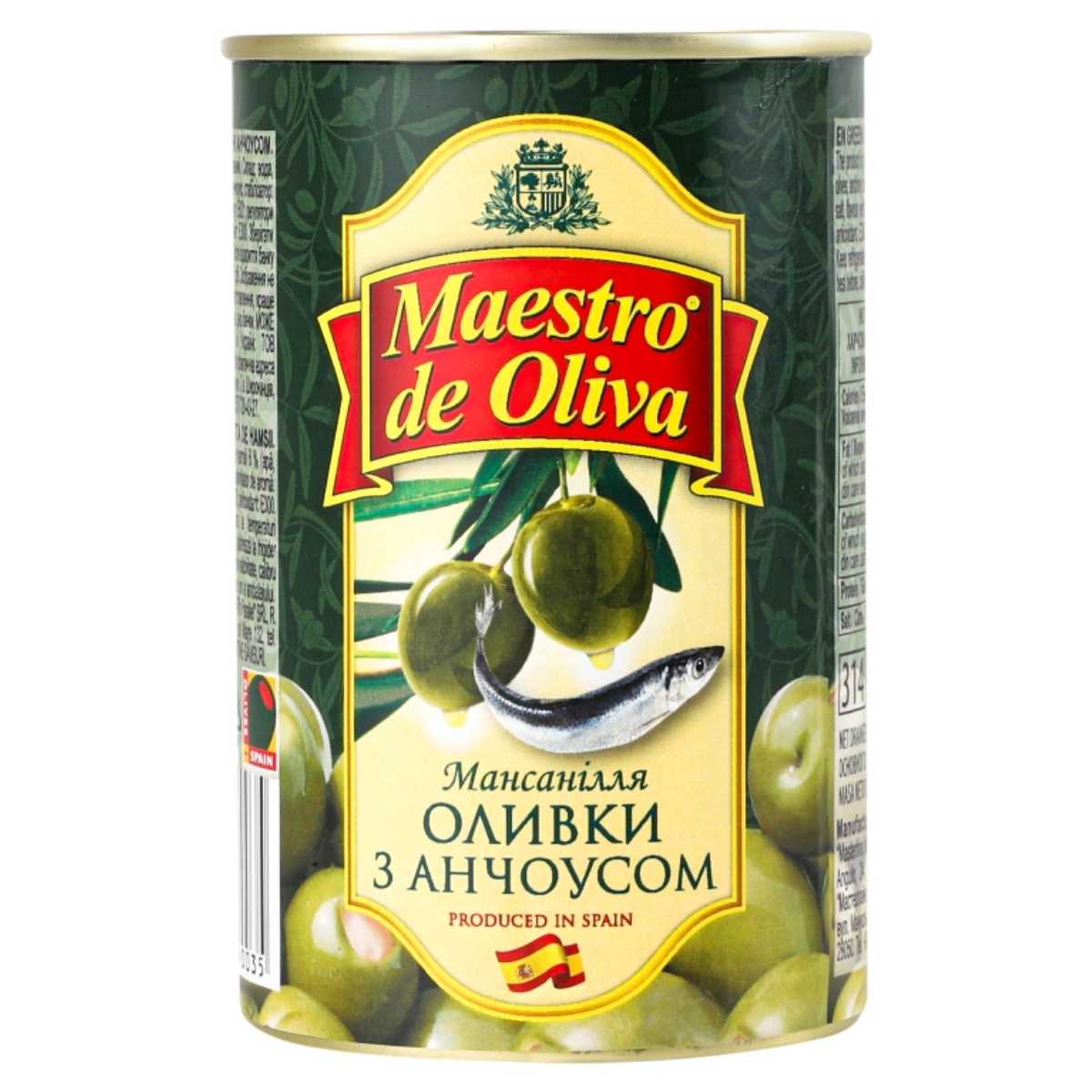 A 300g can of Maestro de Oliva Olives with Anchovy, showcasing a design with olives and an anchovy on the label, which is in Russian. The can states "Produced in Spain. A 300g can of Maestro de Oliva Olives with Anchovy, showcasing a design with olives and an anchovy on the label, which is in Russian. The can states "Produced in Spain.