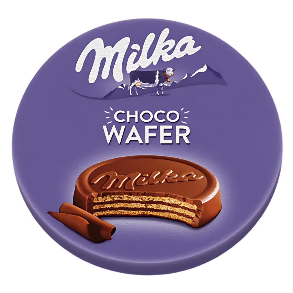 The Milka - Choco Wafer - 30g package, in purple, showcases an inviting image of a creamy chocolate wafer and a playful cow illustration. The Milka - Choco Wafer - 30g package, in purple, showcases an inviting image of a creamy chocolate wafer and a playful cow illustration.