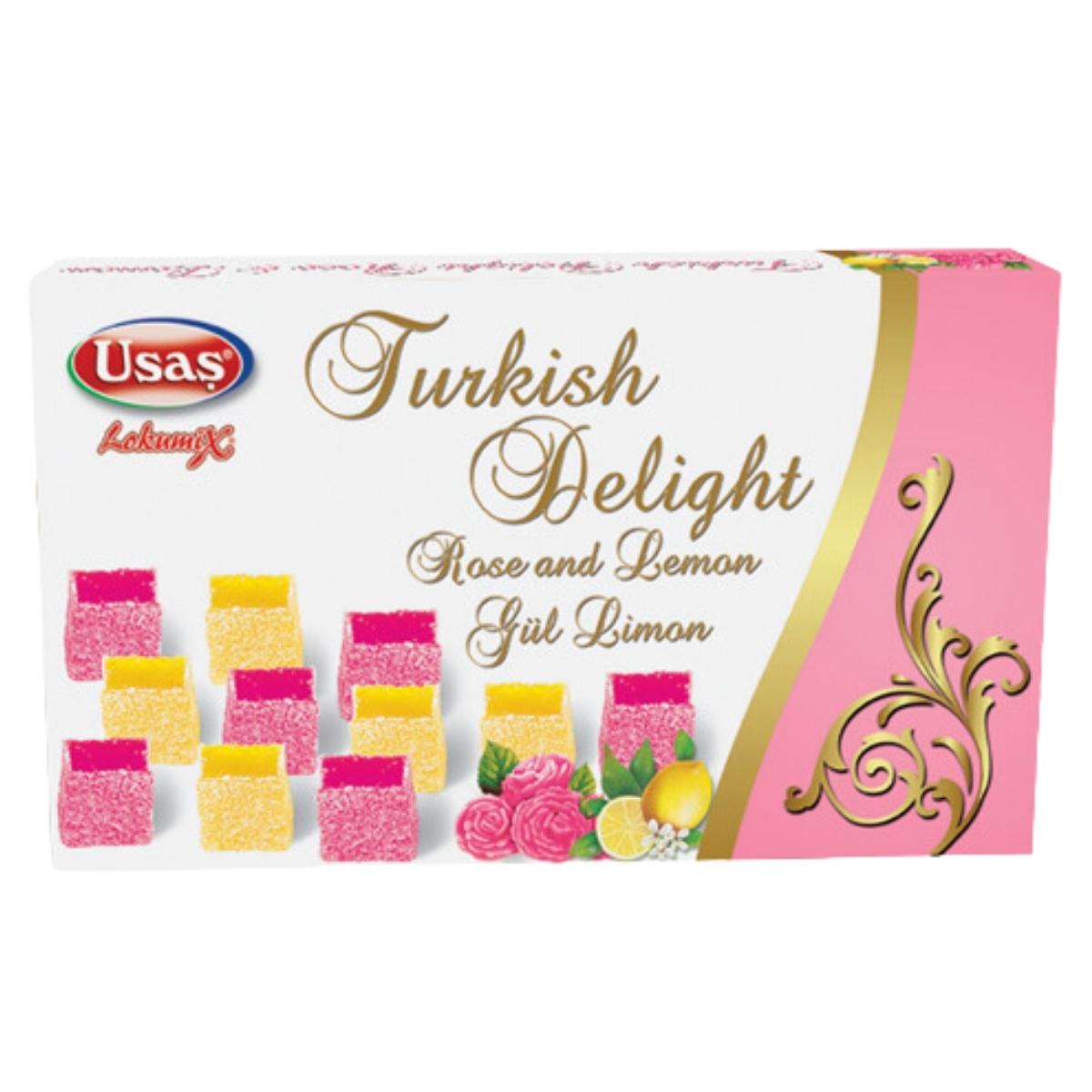Box of Usas Turkish Delight with rose and lemon flavors. The packaging features pink and yellow cube images adorned with floral and lemon illustrations, along with elegant gold swirls. Box of Usas Turkish Delight with rose and lemon flavors. The packaging features pink and yellow cube images adorned with floral and lemon illustrations, along with elegant gold swirls.