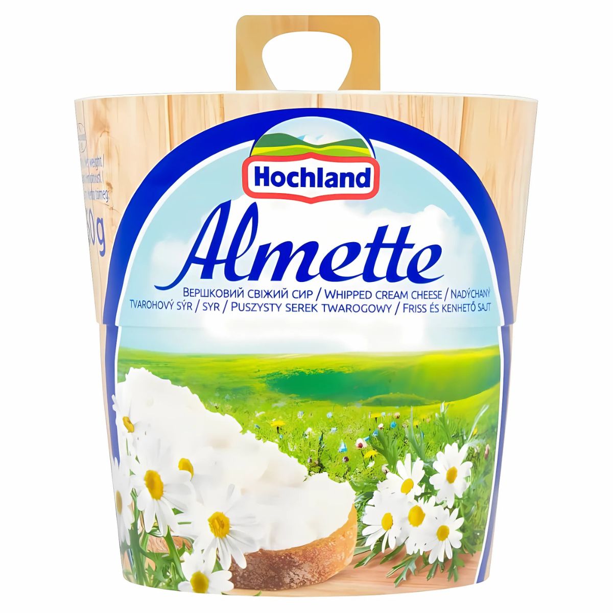 A 150g container of Almette Spreadable Full Fat Soft Cheese, with a label showing creamy cheese, daisies, and a green landscape.