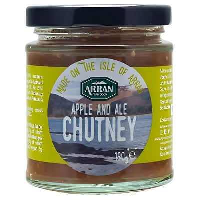 Arran - Apple & Ale Chutney - 190g comes in a glass jar with a yellow "Made on the Isle of Arran" label and a lake image. This savoury chutney is an ideal cheese condiment. Net weight: 190g.