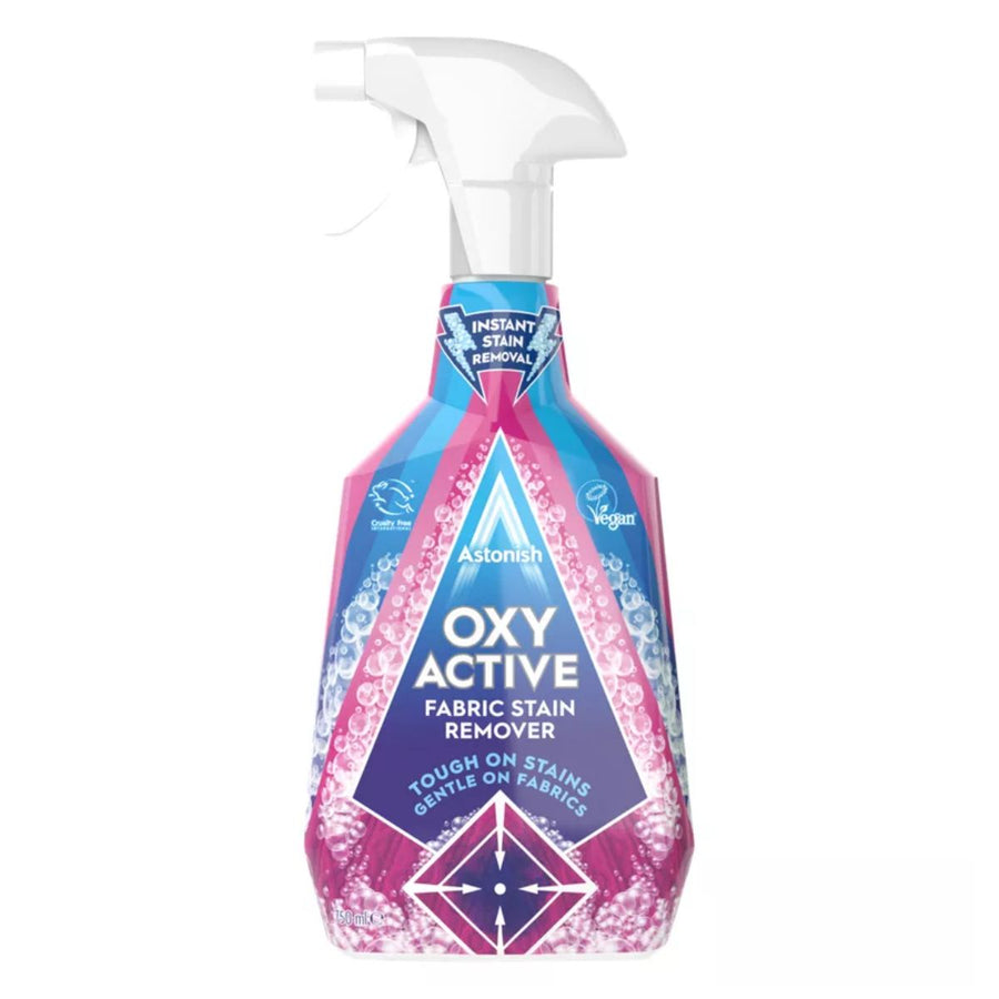 A 750ml bottle of Astonish Oxy Active Fabric Stain Remover Spray with a spray nozzle, featuring a pink and blue label with white text.