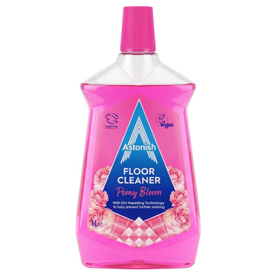 A 1-liter bottle of Astonish - Peony Bloom Floor Cleaner from Astonish, in pink, featuring a screw cap and a label that highlights its dirt-repelling technology as well as its vegan and cruelty-free attributes.