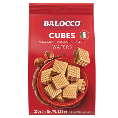 Balocco Hazelnut Wafers (250g) come in a distinctive red package, showcasing stacked wafer cubes and hazelnuts on the front. Made with wheat flour and coconut oil for a light, crispy texture. Net weight: 250g (8.82 oz).
