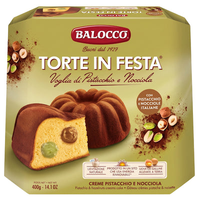 A Balocco Torte In Festa Pistachio & Hazelnut Cream Cake 400g bundt cake with a slice showing pistachio and hazelnut cream fillings, presented on packaging with imagery of nuts and cocoa powder.