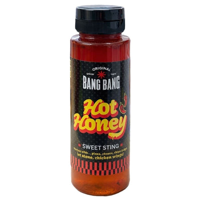 A 350g bottle of Bang Bang Hot Honey features a black label with red and yellow text plus chili pepper illustrations, showcasing this bold spicy honey sauce made with habanero chilli.