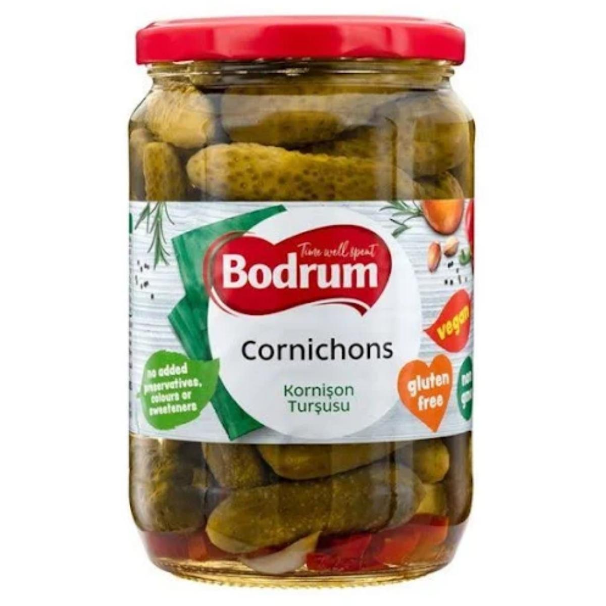 A jar of Bodrum - Cornichons (Kornison Tursusu) with a red lid, weighing 680g. The label highlights that they are gluten-free, vegan, and free from added preservatives, colors, or sweeteners.