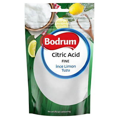 A 100g pack of Bodrum Fine Citric Acid, ideal for cooking and baking, featuring lemons, a wooden spoon, and a green background on the packaging. The label highlights "No artificial colouring.