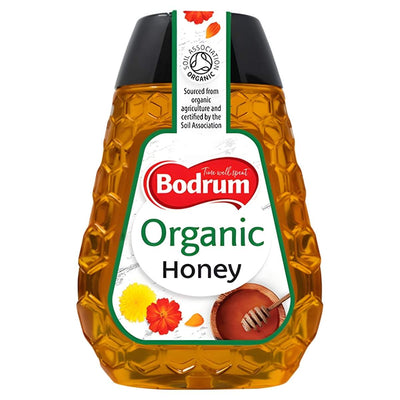 A 250g squeezable bottle of Bodrum Organic Squeezable Honey featuring a honeycomb pattern and Soil Association organic certification.