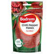 A 100g packet of Bodrum Pepper Flakes with "Pul Biber" labeling, red chili pepper images, and a "100% natural" claim on a green background—ideal for adding authentic spice to Mediterranean dishes.