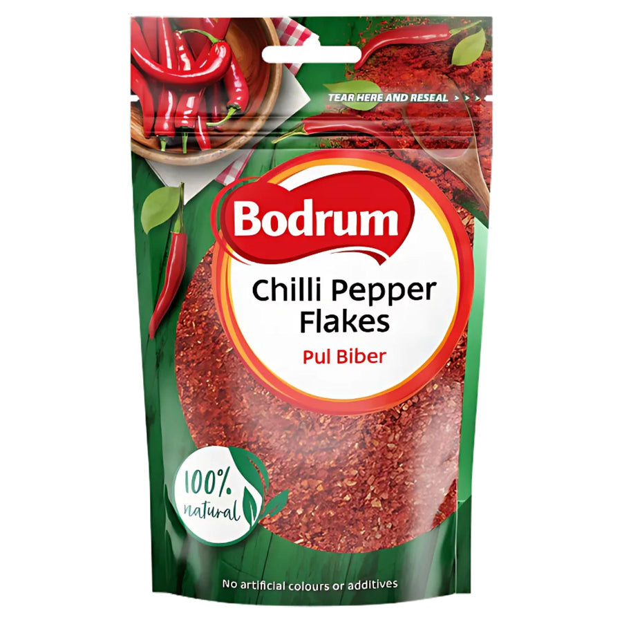 A 100g packet of Bodrum Pepper Flakes with "Pul Biber" labeling, red chili pepper images, and a "100% natural" claim on a green background—ideal for adding authentic spice to Mediterranean dishes.