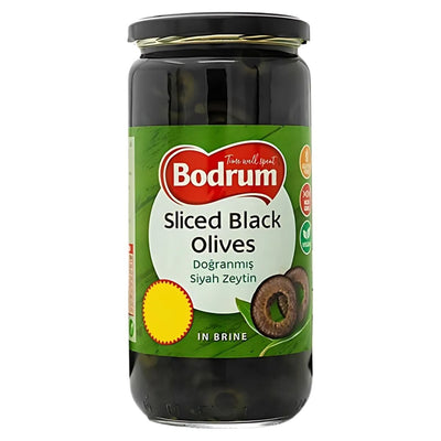 A 680g jar of Bodrum Sliced Black Olives, ideal for Mediterranean dishes, comes with a green label featuring English and Turkish product details.