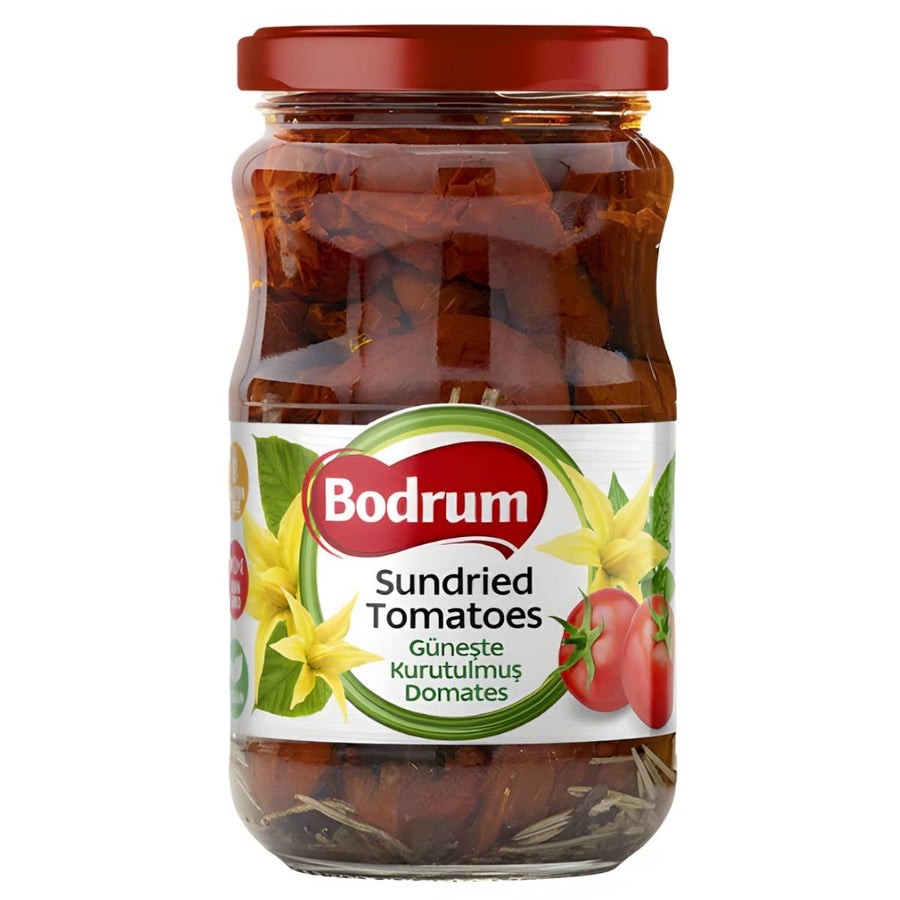 Bodrum Sun Dried Tomatoes In Oil (330g) come in a glass jar with a red lid and a label featuring tomatoes and yellow flowers—ideal for enhancing your dishes with robust Mediterranean flavor.