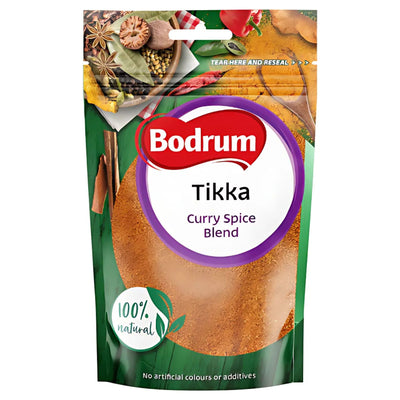 An 85g pack of Bodrum - Tikka Masala Curry Powder made with 100% natural ingredients, featuring a clear window displaying Indian spices and colorful food images on its packaging.