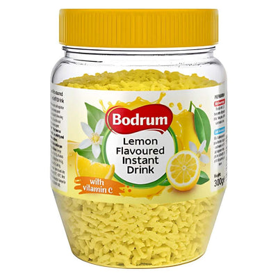 A 300g plastic jar of Bodrum Lemon Flavoured Instant Tea, rich in vitamin C, with yellow granules and a bright label featuring lemons and flowers—an ideal thirst-quencher for any occasion.