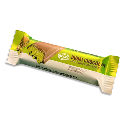 The Bolci - Dubai Chocolate Bar with Kadayif & Pistachio Filling (30g) is displayed in green and white packaging, featuring an image of the chocolate bar and its rich kadayif and pistachio filling on the wrapper.