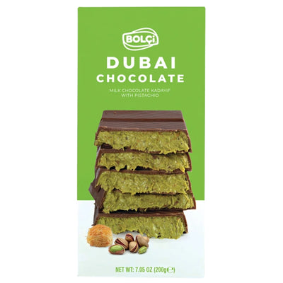 A stack of four Bolci - Premium Dubai Chocolate Bar - 200g segments filled with green pistachio and shredded pastry, with loose pistachios and shredded pastry at the base.