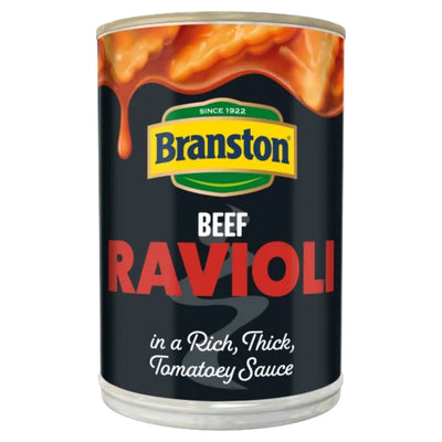 A can of Branston Beef Ravioli in Tomato Sauce (390g), with sauce dripping over the top edge of the label.
