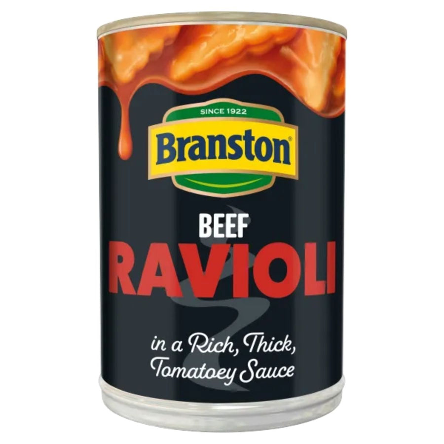 A can of Branston Beef Ravioli in Tomato Sauce (390g), with sauce dripping over the top edge of the label.
