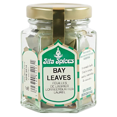 A 5g glass jar of Sita Spices Bay Leaves features a green and white label with product details in several languages—ideal for enhancing your dishes.