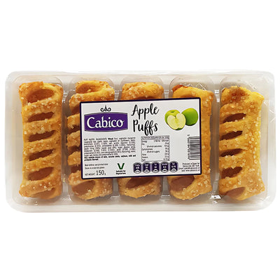 A clear plastic tray holds six Cabico Apple Puffs (150g), a wholesome snack, with a label showing green apples and product info on the front.