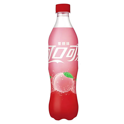 A 500ml Coca Cola - Peach Bottle adorned with branding and illustrations of sparkling peaches on the label, promising a refreshing taste.