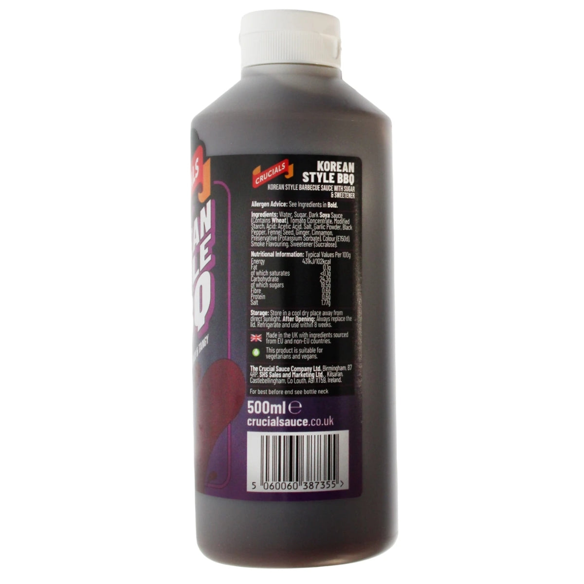 A 500ml bottle of Crucials Korean Style Smoky & Tangy BBQ Sauce with a white cap, displaying product information and ingredients on the back label.