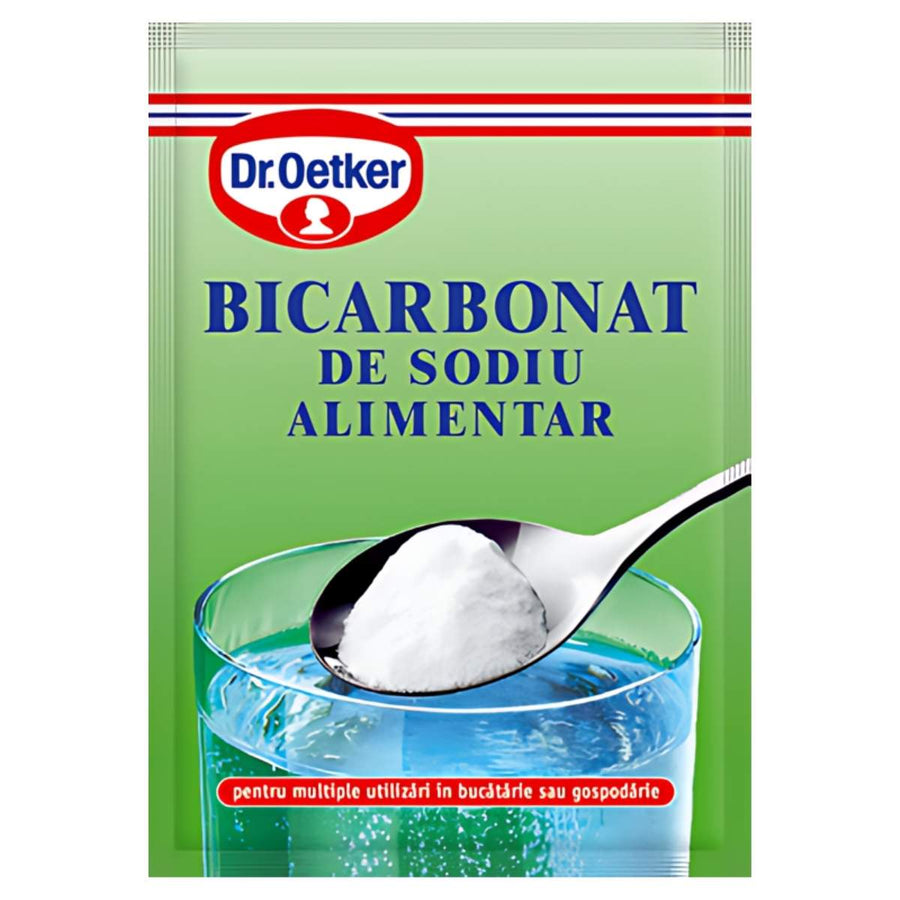 A green Dr.Oetker Bicarbonate Soda 50g pack is shown with a spoonful of white powder above a glass of water, highlighting this trusted baking essential on the packaging.