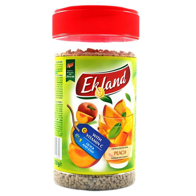 A 350g jar of Ekoland Instant Peach Flavour Tea with a red lid and green label, featuring juicy peaches and a glass of juice, highlights it as granulated tea rich in vitamin C.