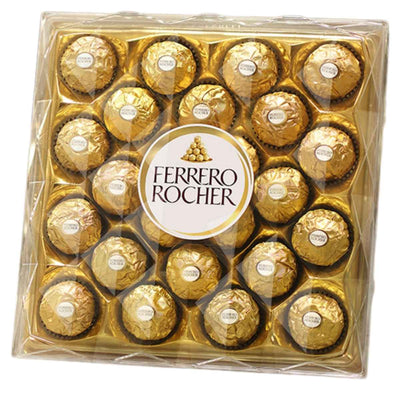 A clear plastic box of Ferrero Rocher - Original Hazelnut Chocolate Box - 300g displays 24 chocolates wrapped in rich gold foil, filled with hazelnut and chocolate, centered around the iconic Ferrero Rocher logo.