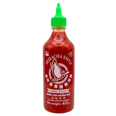 A 455ml bottle of Flying Goose Sriracha Hot Chilli Sauce with a green cap and vivid red sauce, labeled in English, Vietnamese, and Chinese.