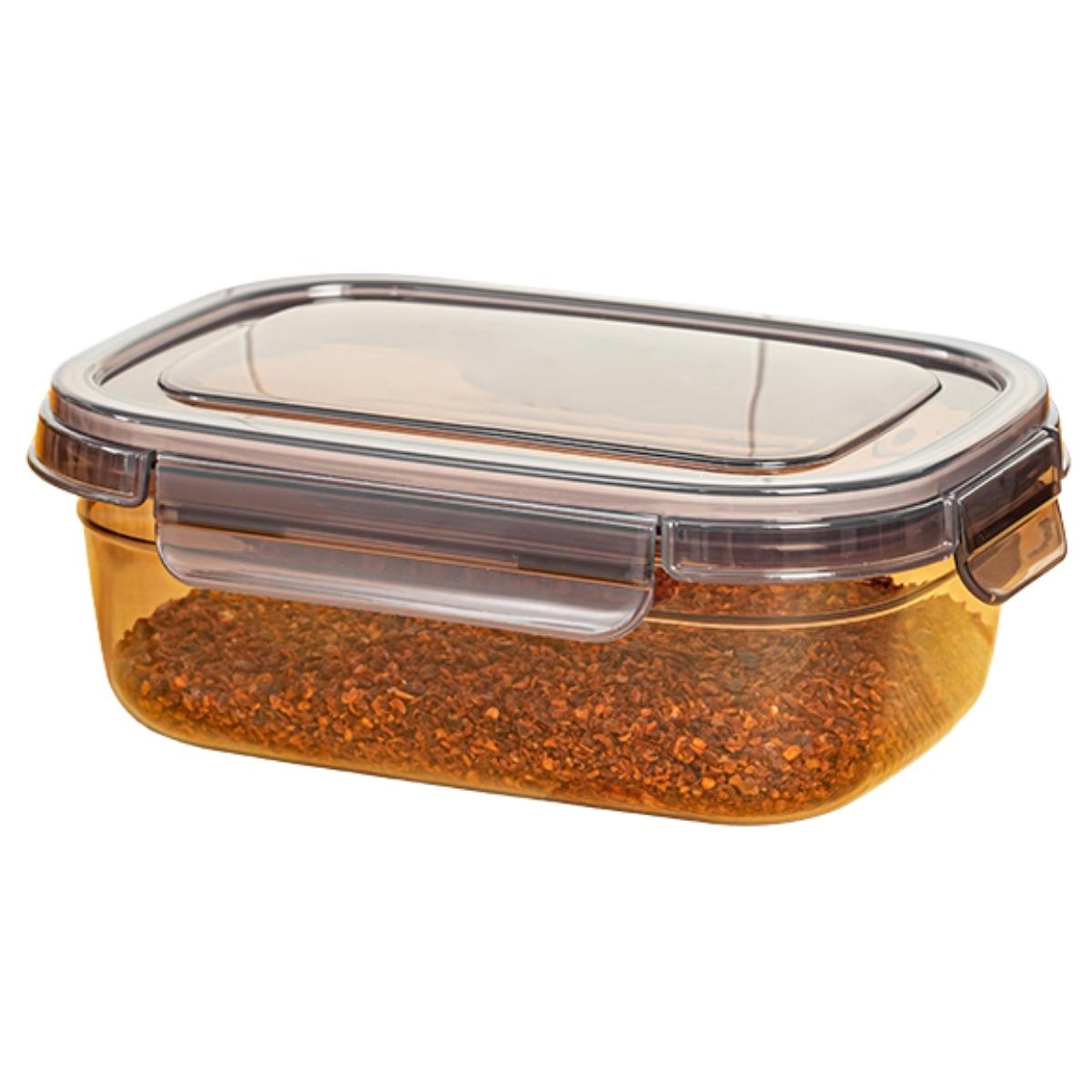 The Foly Life Tesny Plastic Airtight Storage Container (670ml) is a rectangular, amber-tinted transparent container with a lid, shown filled with a granular reddish-brown substance.