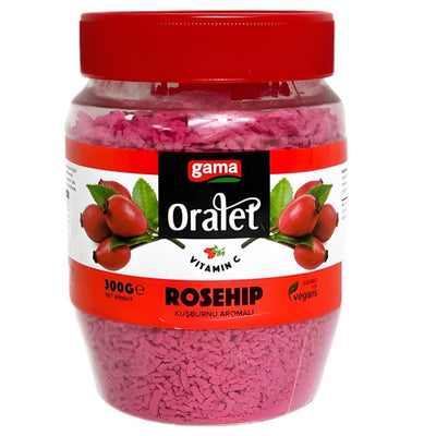 A 300g jar of gama Oralet Rosehip Flavoured Instant Tea with a red lid, labeled vegan and vitamin C-rich. The label shows rosehip illustrations, making it ideal for a refreshing vitamin C tea experience.