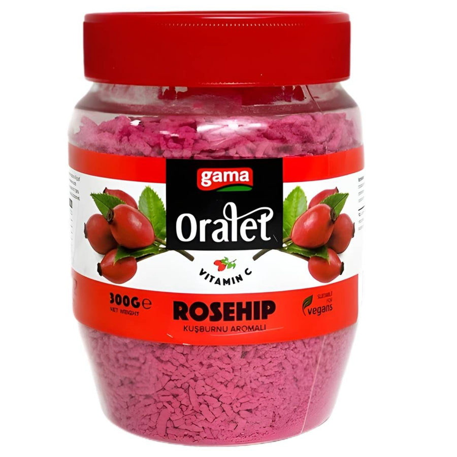 A 300g jar of gama Oralet Rosehip Flavoured Instant Tea with a red lid, labeled vegan and vitamin C-rich. The label shows rosehip illustrations, making it ideal for a refreshing vitamin C tea experience.