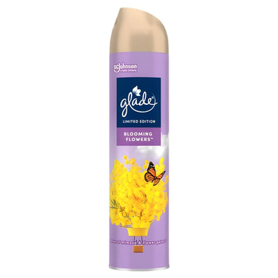 A 300ml can of Glade Blooming Flowers Air Freshener Spray features a floral scent with yellow flowers and a butterfly on a purple background.
