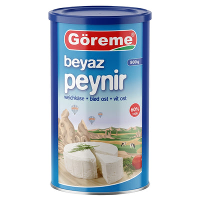 Blue cylindrical container of Goreme - White Cheese 60% Fat (Halal) - 1500g featuring a landscape illustration with hot air balloons and a graphic of a sliced wheel of white cheese.