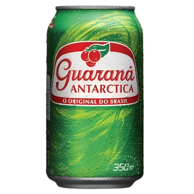 A 330ml can of Guarana – Antarctica, the iconic Brazilian soft drink, featuring a green background, red and white logo, and visible condensation droplets.