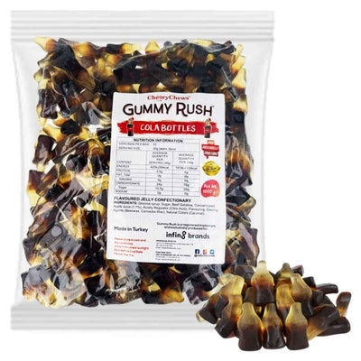 A clear bag labeled "Gummy Rush - Cola Bottles - 1Kg" from Gummy Rush is filled with chewy cola-flavored gummies, with some gummy candies displayed in front of the bag.