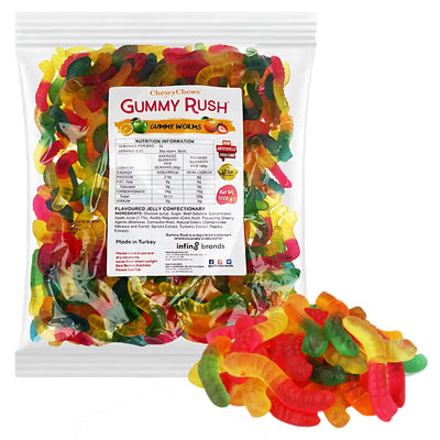 A clear 1Kg pack labeled "Gummy Rush - Gummy Worms (Halal)" from Gummy Rush, filled with colorful Halal gummy worms, with a small pile of gummies displayed in front of the bag.