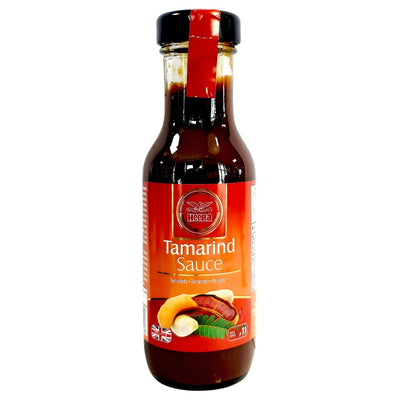 Heera - Tamarind Sauce - 250ml is a tangy and sweet condiment by Heera, featuring a red label with tamarind pods and a British flag—perfect to add flavor to all your favorite dishes.