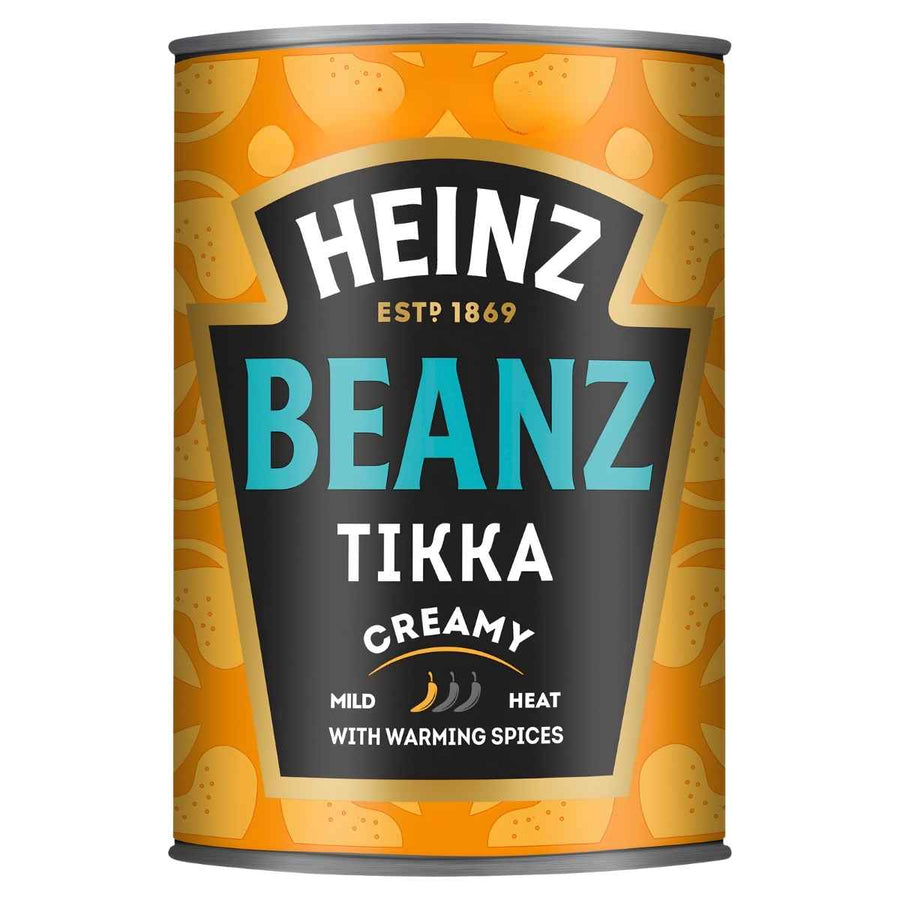 A 390g can of Heinz Tikka Creamy Beanz, with an orange and black label and “Mild Heat with warming spices,” offers creamy beanz in authentic Indian tikka masala flavor.