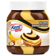 A jar of Kent Boringer Duo Spread Banana & Hazelnut spread, showing the brown and yellow spread inside the clear jar, with a white cap and a label featuring bananas, hazelnuts, and a toast with spread.