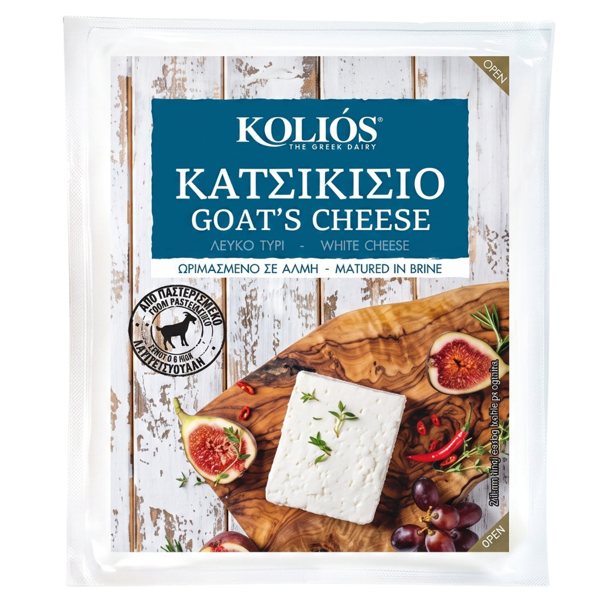 A package of Koliós Goat's Cheese (KatekisiΕ) in a clear plastic clamshell package. The front label features a rustic white wood background with a prominent dark blue banner containing the brand name 'KOLIΕS THE GREEK DAIRY' in white.