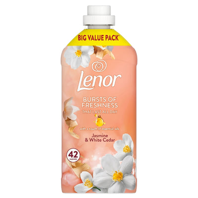 A peach-colored bottle of Lenor Jasmine & White Cedar Fabric Conditioner (1.386L, 42 washes) features white flowers on the label and is labeled as a big value pack.