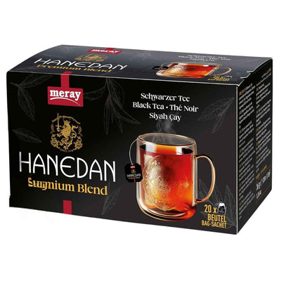 Box of Hanedan black tea with a glass mug on a white background