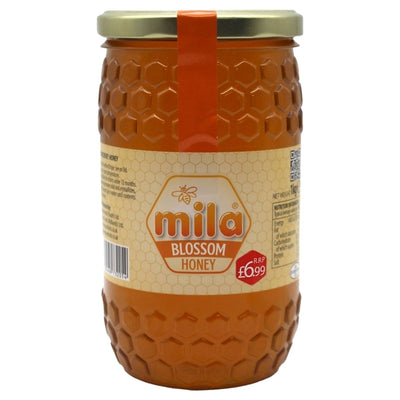 Experience pure Mila Blossom Honey in a 1kg glass jar with honeycomb design and gold lid. The label displays "Mila - Blossom Honey Glass Jar - 1kg" and it's priced at just £0.99. Enjoy natural honey in elegant packaging.